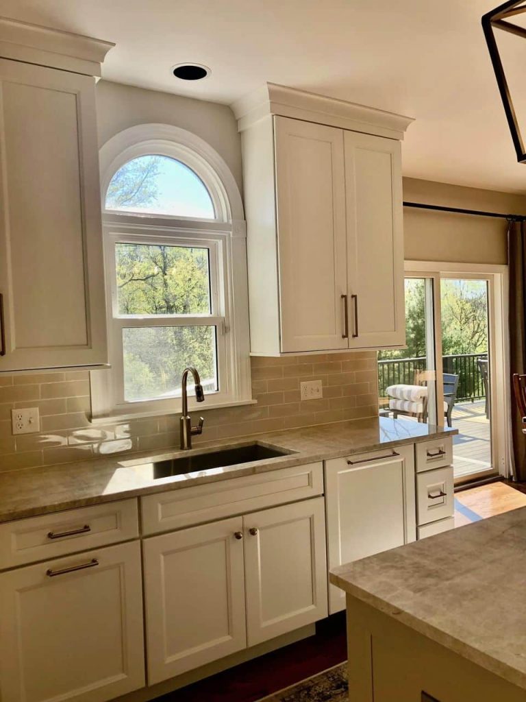 A kitchen with warm wooden cabinets