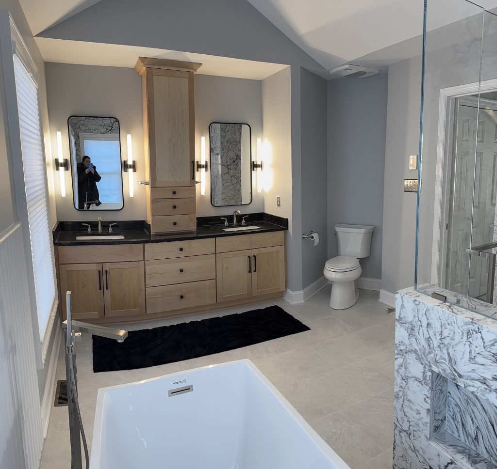 A bathroom with a deep tub and double vanity