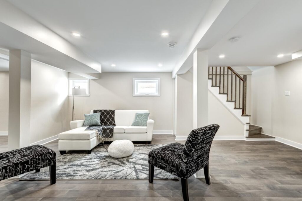 A basement with white walls and furniture
