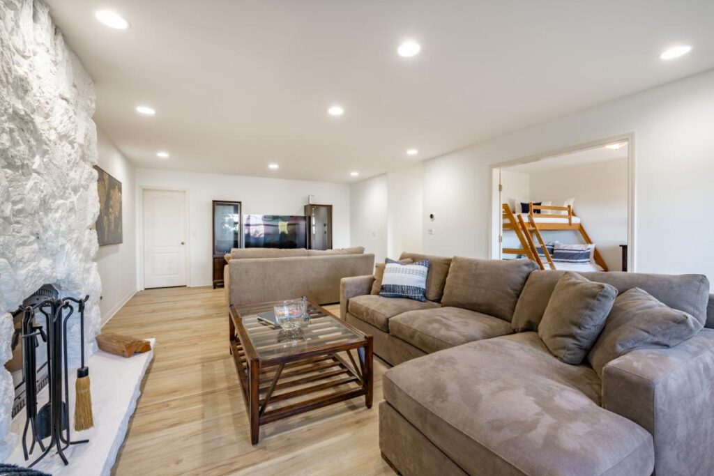 A basement with white walls and hardwood floors