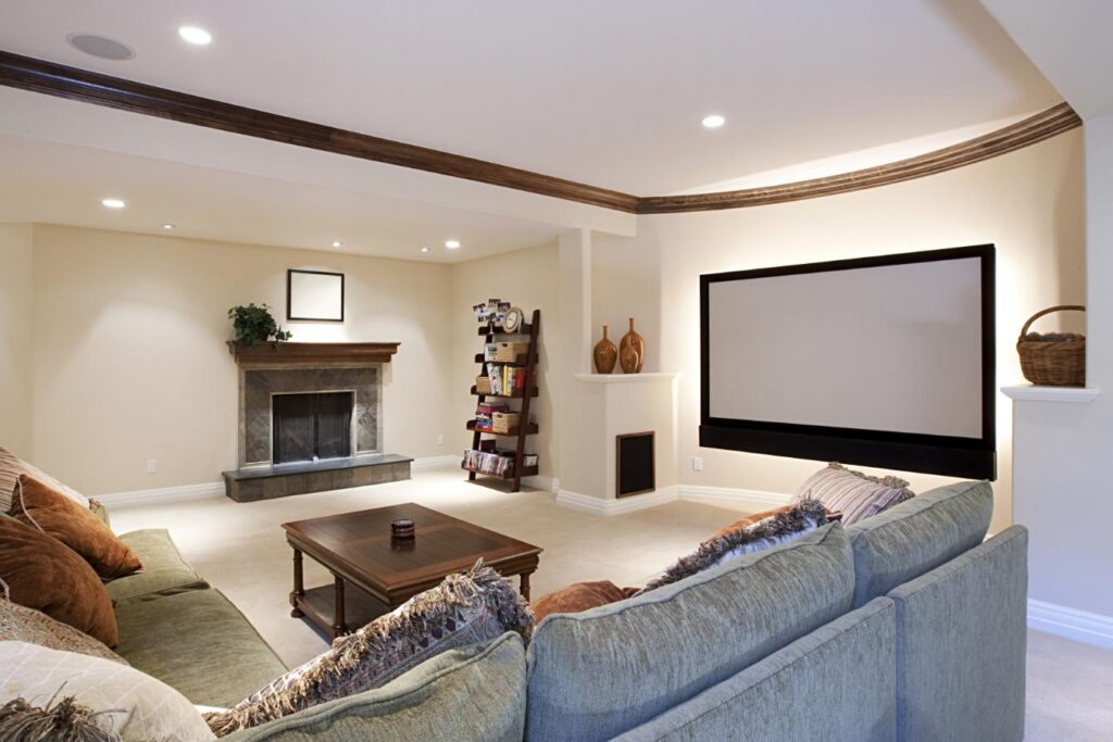 A large basement with a fireplace and wall-mounted television